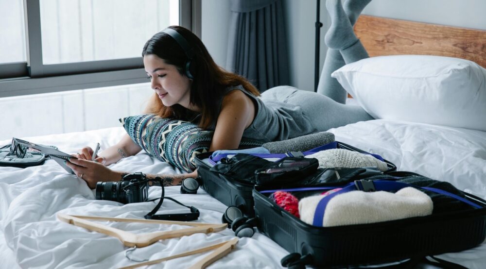 Girl preparing for her trip showing essential travel gadgets every traveler needs