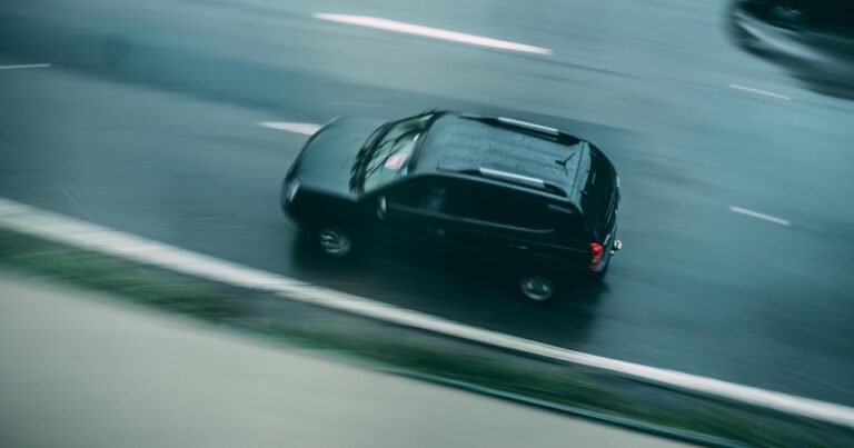 A car driving on the road showing the experience of driving an EV