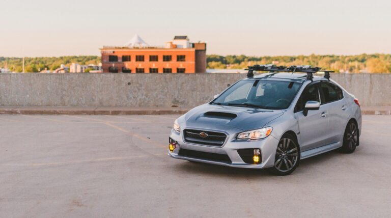 A silver and black car in a roof top packing