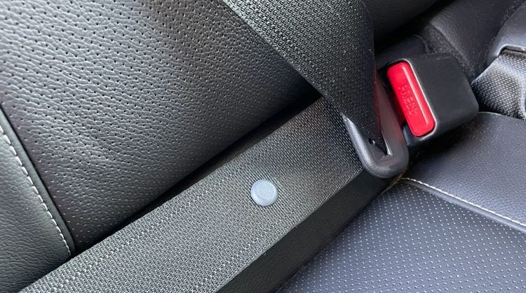 The tiny seatbelt button is a car secret with a hidden function